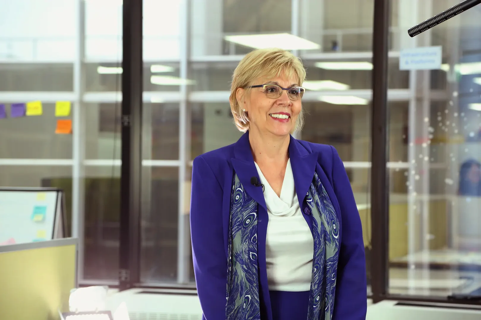Arlene White, Chief Executive of EPL, stands in a professional setting wearing a blue blazer and white blouse. The background appears neutral, keeping the focus on her, suggesting a formal portrait for corporate or leadership communications