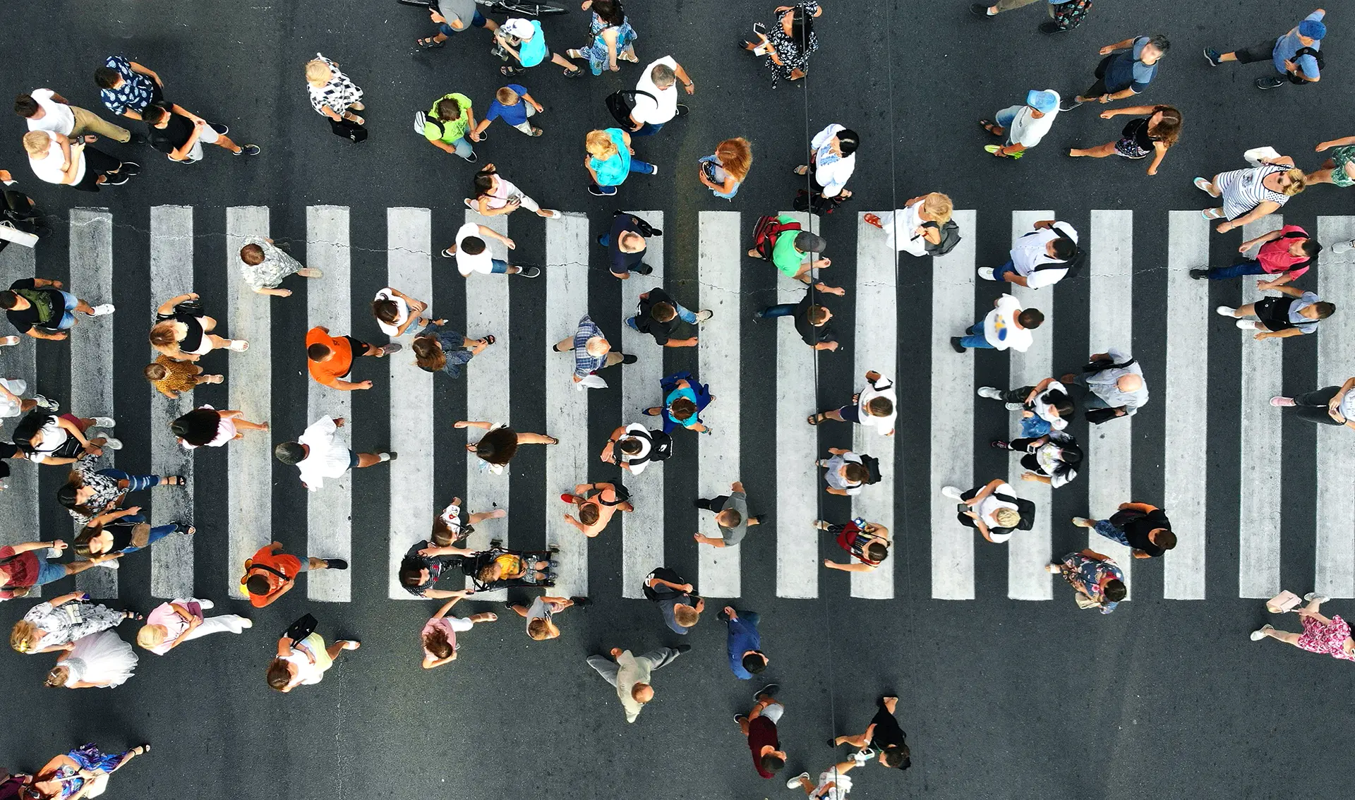 Crowd of people crossing a busy intersection, symbolizing high user traffic to a website.