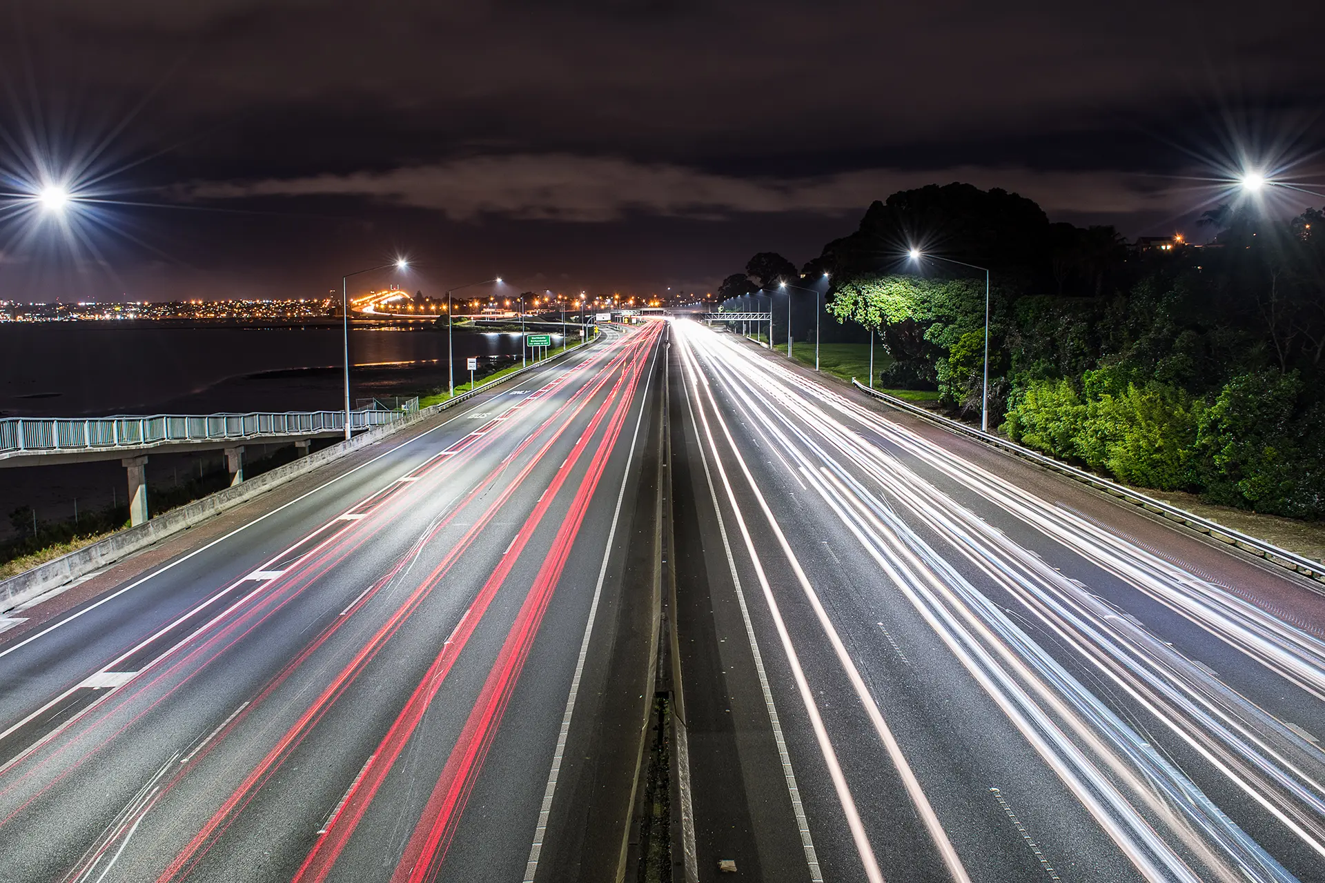Night view of busy city highway with light trails, symbolizing the need for reliable car and travel insurance to protect against life’s unexpected journeys and road risks.